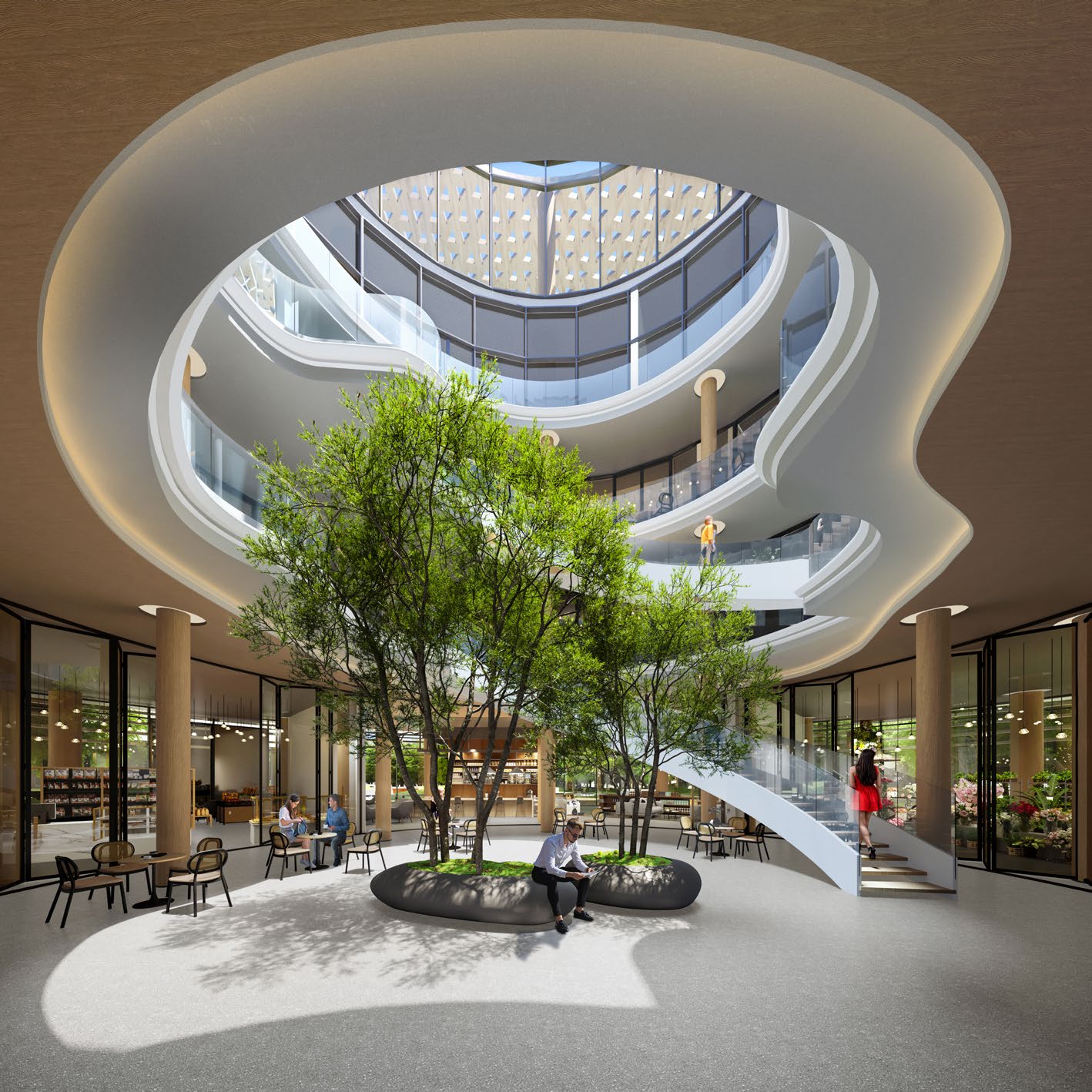 Clubhouse atrium with trees, café tables and a curving staircase