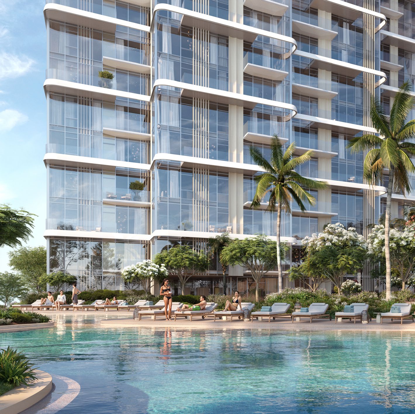Pool with sun loungers and palms at the foot of a tower