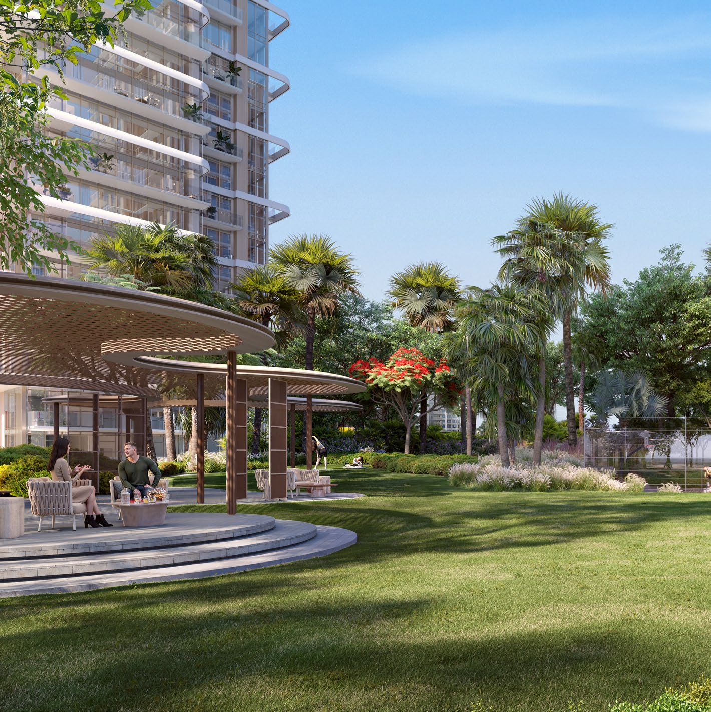 Open lawn with shaded seating pavilion and palms beside a tower