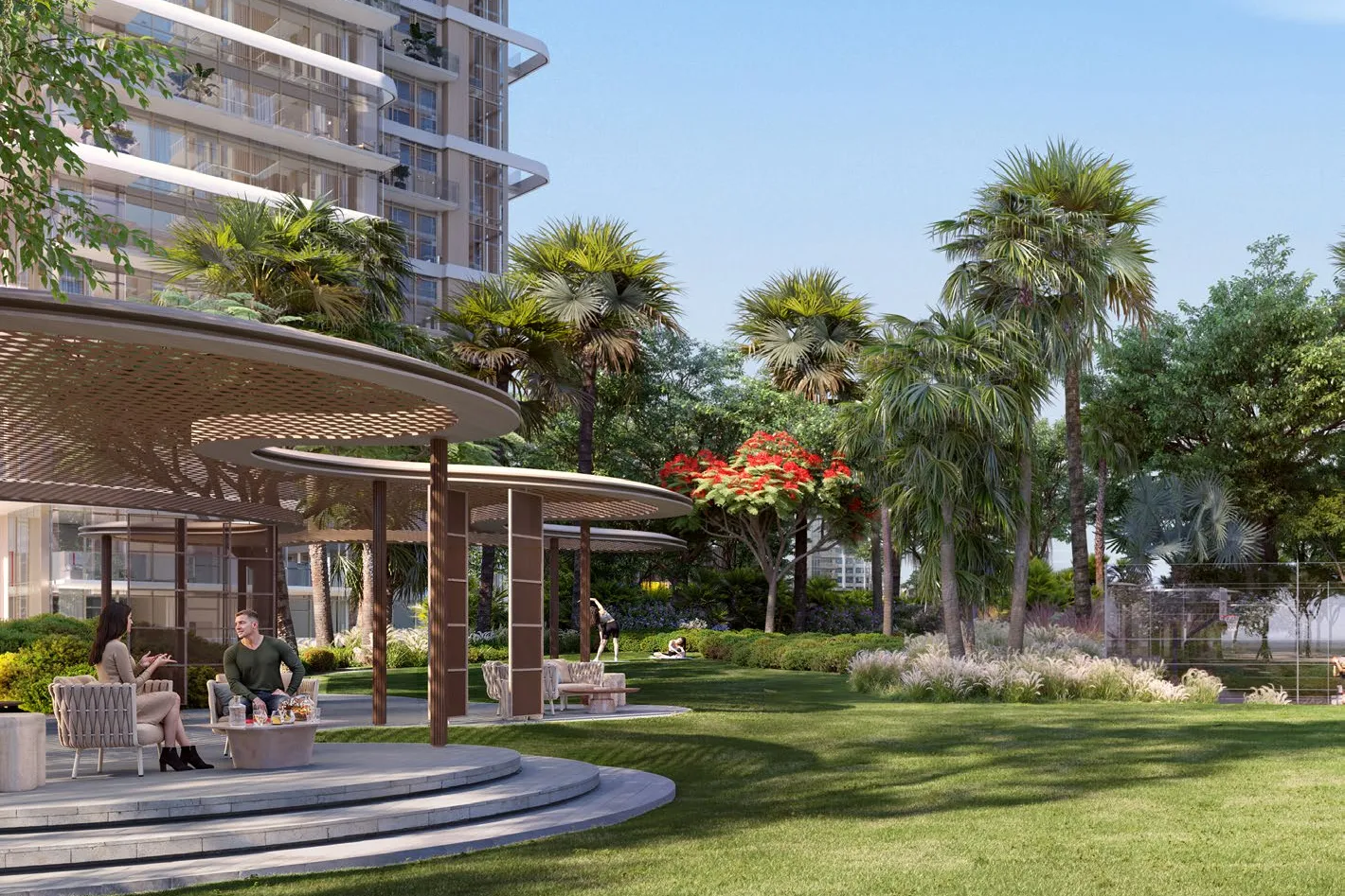 Open lawn with shaded seating pavilion and palms beside a tower